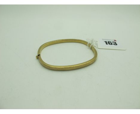 A Modern Hinged Bangle, of plain design, stamped "375" (6.5grams). 