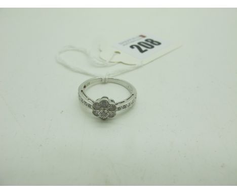 A Modern 9ct White Gold Diamond Cluster Ring, illusion set, stamped .51" (finger size O) (2.3grams). 