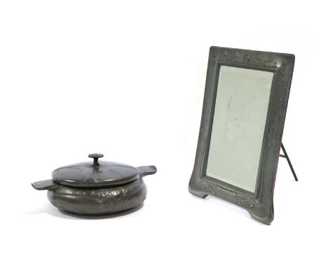 An Art Nouveau Pewter Easel Toilet Mirror, the top with three interlinking circles surrounded by sinuous plants, stained wood