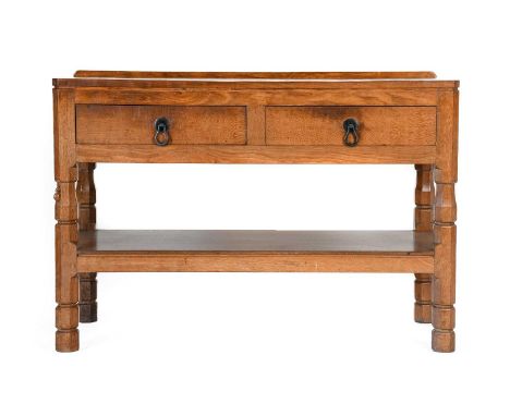 Robert Mouseman Thompson (1876-1955): An English Oak Serving Table, with raised upstand, the rectangular adzed top, above two