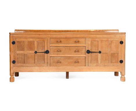 Workshop of Robert Mouseman Thompson (Kilburn): A Panelled English Oak 6ft Sideboard, with raised upstand over two cupboard d