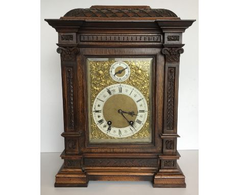A circa 1900 German carved oak cased mantel clock, the eight day movement by Lenzkirch stamped to the back plate ''56 Lenzkir