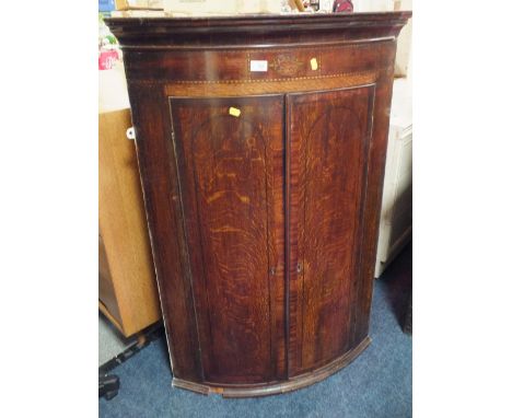 A 19TH CENTURY OAK AND INLAID BOW FRONTED HANGING CORNER CUPBOARD, H 115 cm,. W 79 cm