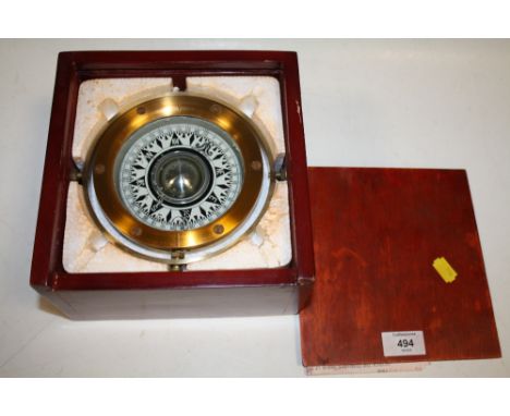 A CASED BRASS SHIPS COMPASS