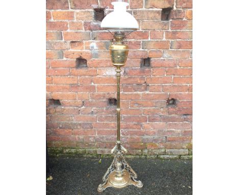 A LATE 19TH CENTURY EXTENDING BRASS LAMP STANDARD WITH HINKS BURNER, the reservoir with incised foliate decoration, with glas