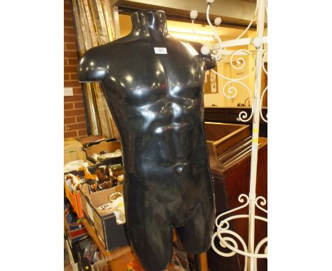 A SHOP DISPLAY MANNEQUIN TORSO ON STAND