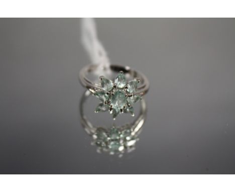 AN 18 CARAT WHITE GOLD GEM SET RING, in a floral style with light green stones, approx weight 4g, ring size N 1/2