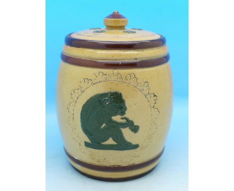 A Doulton Lambeth relief moulded tobacco jar and cover, with decoration of an ape smoking a pipe, chips to rim of cover