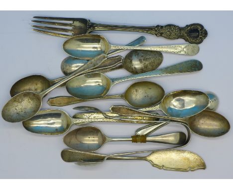 A collection of silver spoons including Georgian, a fork and sugar bows, 215g
