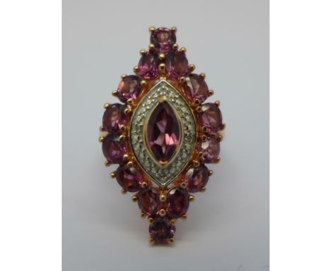 A silver gilt, rhodolite garnet and diamond set ring, M