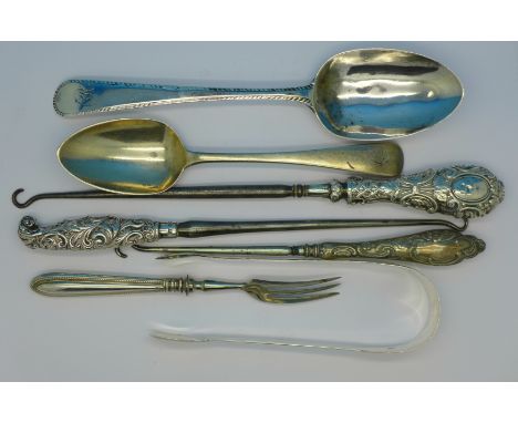 A George III 18th Century silver spoon, London 1782, one other silver spoon, a pair of silver sugar bows, three button hooks 
