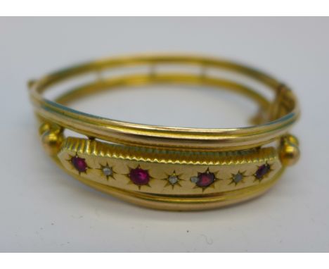 A yellow metal, diamond and red stone bangle, 15g