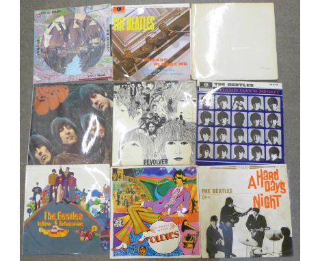 Eleven Beatles LP records and a George Harrison LP record including The White Album, No. 04790XX, Abbey Road picture disc, A 