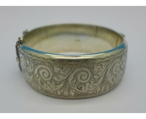 A hallmarked silver bangle with inscription dated 1962