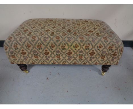 An oversized footstool in tapestry fabric, 93 x 52 x 42 cm. 