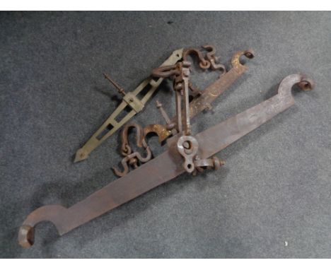 Three antique balance scale arms (two wrought iron, one brass)