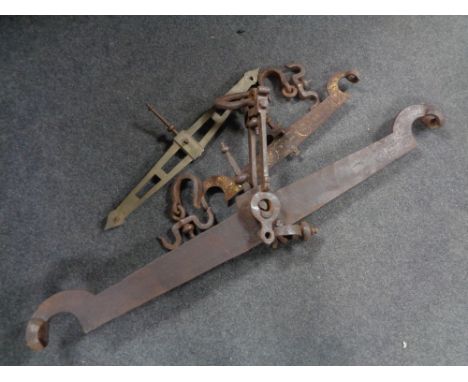 Three antique balance scale arms (two wrought iron, one brass)