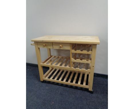 A pine kitchen butcher's block trolley fitted with drawers, wine rack and shelf 