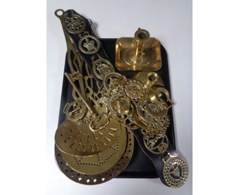 A tray containing assorted brass ware to include horse brasses, a brass key candlestick, chestnut roasters.  