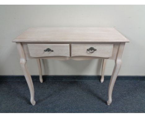 A contemporary two drawer console table in a washed pine finish.  