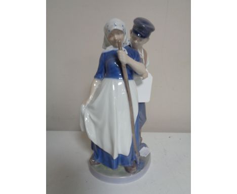 A Royal Copenhagen figure number 1300 - couple in traditional Dutch clothing carrying tools 