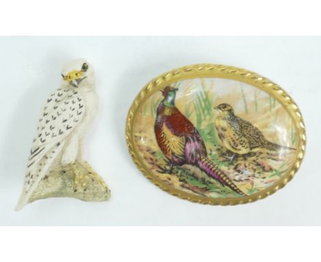 Aynsley Ceramic Brooch: A ceramic Aynsley brooch decorated with pheasants together with a similar brooch. (2)