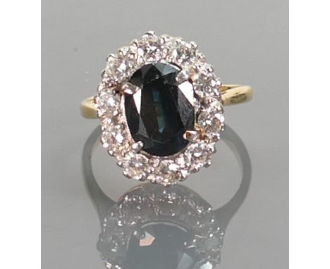 18ct yellow gold Sapphire & white stone cluster ring: Sapphire measures 10mm x 7mm, ten white stones set in platinum.  Gross 