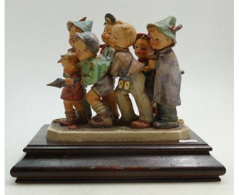 Goebel Hummel figure group Follow my Leader: A group of 7 comical children marching with a spear on wood plinth, height 24cm 