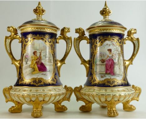 Pair of Coalport two handled Urn & covers: Stunning pair of footed urns both painted by T Keeling, each with a romantic scene