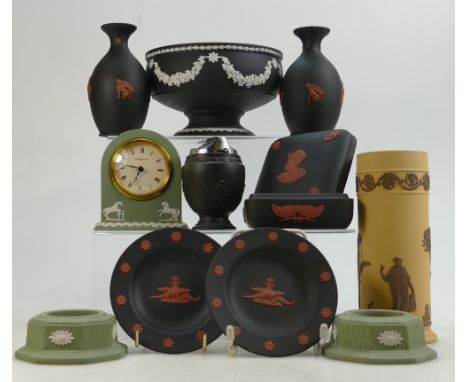 A collection of Wedgwood items to include: Coral on black lidded boxes, vase, sage green candlesticks and mantle clock, brown