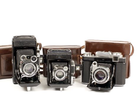 A Group of Three Zeiss Ikon Super Ikonta Cameras. Comprising Super Ikonta 531/2 with CZJ Tessar f3.8 10.5cm lens (slight dama