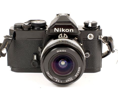 Black Nikon FM with 20mm Nikkor Lens. Camera body #2324037 (covering slightly lifting at one edge, otherwise condition 4/5F) 