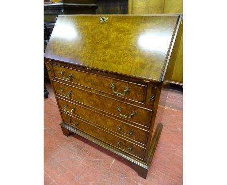 A REPRODUCTION WALNUT FALL FRONT BUREAU CHEST on corner bracket feet, 96 cms high, 80 cms wide, 43 cms deep