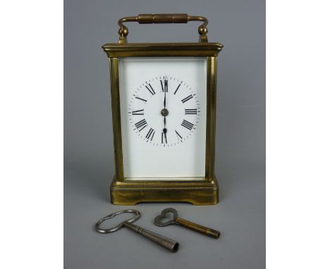 A BRASS CASED CARRIAGE CLOCK with visible platform escapement, 17.5 cms high top of handle