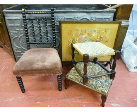 AN EBONIZED BOBBIN CHAIR, two footstools and a needlework firescreen, various measurements