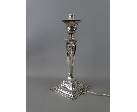 A SILVER CANDLESTICK with classical swag decoration, tapering column and stepped square base, Birmingham 1930, 30 cms high (c