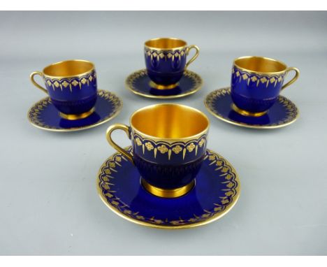 FOUR COALPORT GILT INTERIOR COFFEE CUPS AND SAUCERS, cobalt ground with gilt highlighting, factory backstamps (slight wear), 
