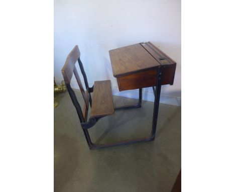 A vintage childs school desk, on an iron frame 