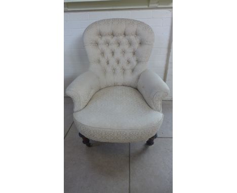 A Victorian button back armchair 