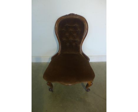 A 19th century ladies button back armchair with cabriole legs and brown velveteen upholstery 