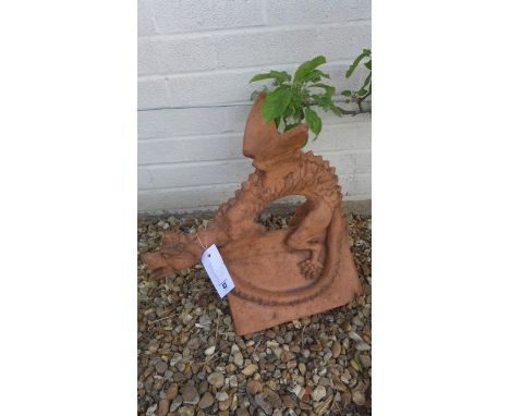 A terracotta roof ridge tile surmounted by a winged dragon - 44cm H x 46cm L x 26cm W 