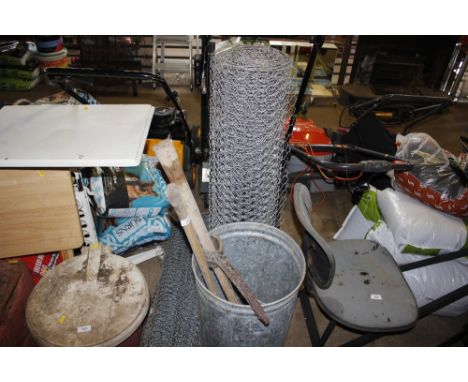 A galvanised bucket and contents of axe, pick axe etc.and three rolls of chicken wire 