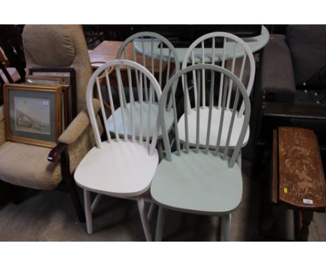 A circular painted table; and four painted stick back chairs 