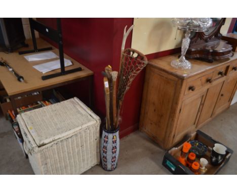 A pottery stick stand and contents of various walking sticks, le cross racket etc.