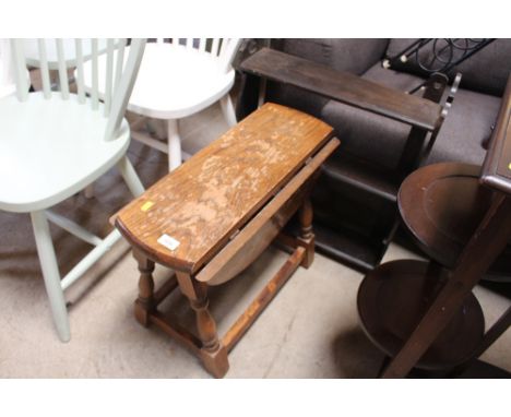 An oak drop leaf table and a wall shelf 