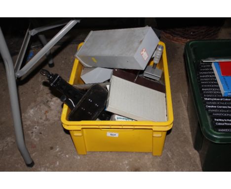 A box containing slide boxes, car jack, various hand tools etc.