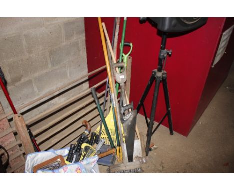 A quantity of long handled garden tools; hand saw; carpet sweeper; broom etc.