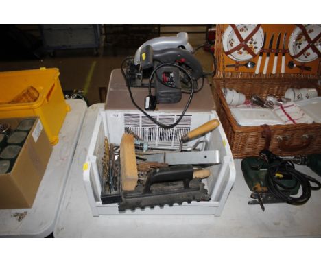 A circular saw; and a box of various tools to include drill and router bits 