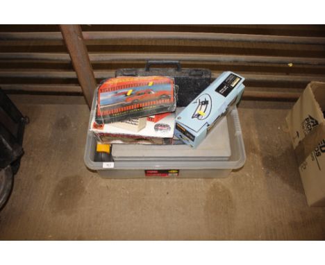 A box containing car pump, battery charger and various tools