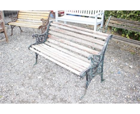 A cast iron and wooden garden bench